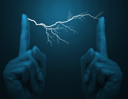 An electrical bolt between a woman's fingers
