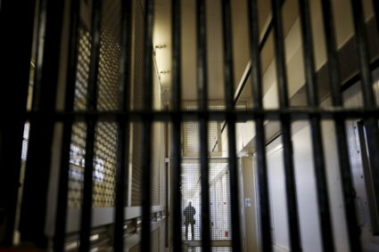 A guard stands behind bars at the Adjustment Center during a media tour of California's Death Row at San Quentin State Prison in California. Picture taken December 2015. Photo by Stephen Lam/Reuters