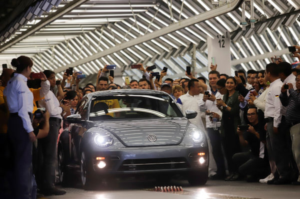 Employees take pictures of a Volkswagen Beetle car during a ceremony marking the end of production of VW Beetle cars, at company's assembly plant in Puebla, Mexico, July 10, 2019. Photo by: Imelda Medina/Reuters