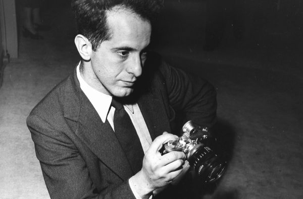 Robert Frank holding a pre-war Leica camera in 1954. Photo by Fred Stein Archive/Archive Photos/Getty Images