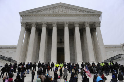 Police form a line after arresting demonstrators on the steps of the U.S. Supreme Court building, on the 2012 anniversary of the Citizens United decision, in Washington. Under the banner 'Occupy the Courts,' organizers expect thousands of people to rally on Friday at 150 courthouses to mark the second anniversary of the Supreme Court ruling that protesters say allows unlimited corporate campaign donations. Photos By Jonathan Ernst via Reuters.