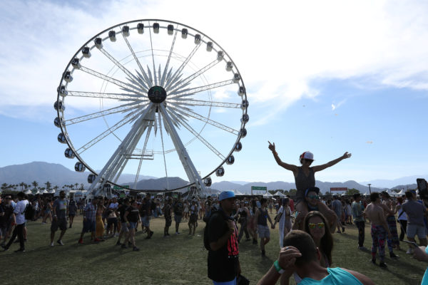 People pose for photos during the Coachella Valley Music and Arts Festival in Indio, California. Photo by Carlo Allegri/Reuters