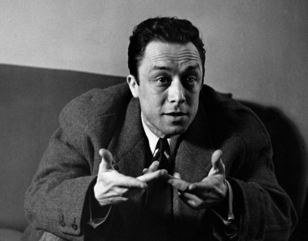 Albert Camus gestures in discussion. Photo by © Hulton-Deutsch Collection/CORBIS/Corbis via Getty Images