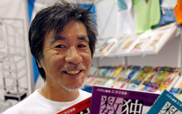 FILE PHOTO: 'Father of Sudoku' Maki Kaji holds copies of the latest sudoku puzzles at the Book Expo, in New York