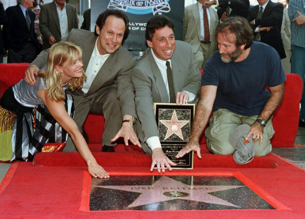 Film director Ivan Reitman poses with his plaque after his star on the Hollywood Walk of Fame was un..