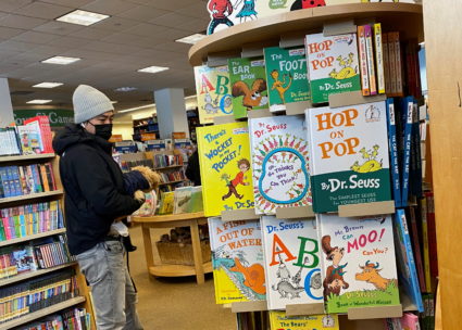 A customer looks at books by Dr. Seuss in a bookstore in Brooklyn