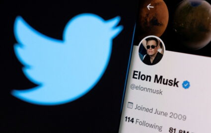 Elon Musk's twitter account is seen on a smartphone in front of the Twitter logo in this photo illustration taken, April 15, 2022. Photo by Dado Ruvic/Illustration/REUTERS