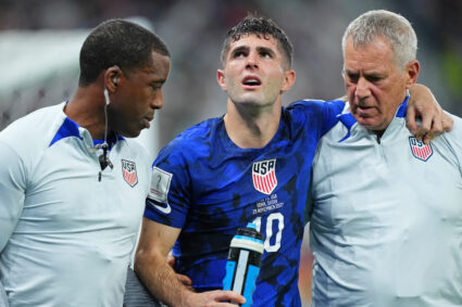 United States of America forward Christian Pulisic (10) is helped after sustaining an injury after colliding with Iran goalkeeper Alireza Beiranvand (1) following his goal during the first half of a group stage match during the 2022 World Cup on Nov. 29, 2022 at Al Thumama Stadium. Photo by Danielle Parhizkaran-USA TODAY Sports