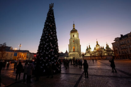 People gather around a Christmas tree at the Sofiyska Square in Kyiv