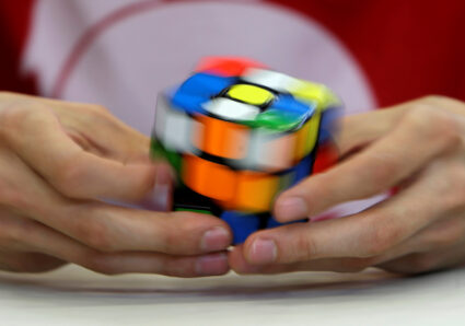 A competitor solves a Rubik's cube during the Rubik's Cube European Championship in Prague