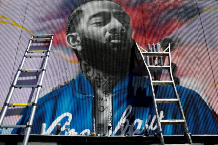 A mural is pictured as people mourn the shooting death of musician Nipsey Hussle outside of his The Marathon Clothing store on Slauson Avenue in Los Angeles, California on April 7, 2019. Photo by Patrick T. Fallon/Reuters