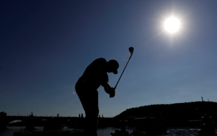 A golf player chips a shot from a boat on the Vltava river near the medieval Charles bridge during a promotion event before the Czech Masters golf tournament in Prague, Czech Republic August 29, 2017. Photo by David W Cerny/REUTERS