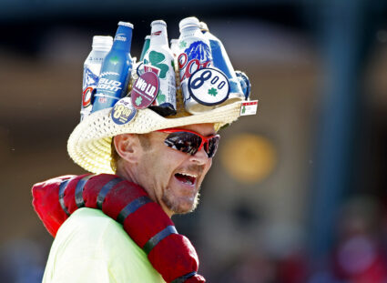 A beer vendor displays products on his hat as he works the crowd during the MLB Cactus League spring training baseball game between the Los Angeles Angels and San Francisco Giants in Tempe, Arizona, March 24, 2013. Photo by Ralph D. Freso/REUTERS