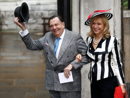 FILE PHOTO: Comedian Barry Humphries and his wife Lizzie Spender pose for a photograph as they arrive at St Bride's church...