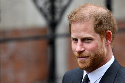 FILE PHOTO: Britain's Prince Harry walks outside the High Court, in London