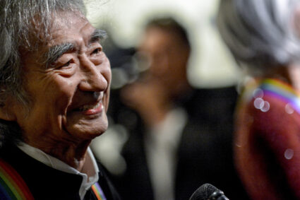 FILE PHOTO: Conductor Seiji Ozawa walks the red carpet before the Kennedy Center Honors at the Kennedy Center in Washington